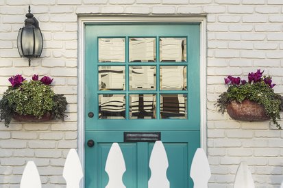 Front Door of House with White Picket Fence
